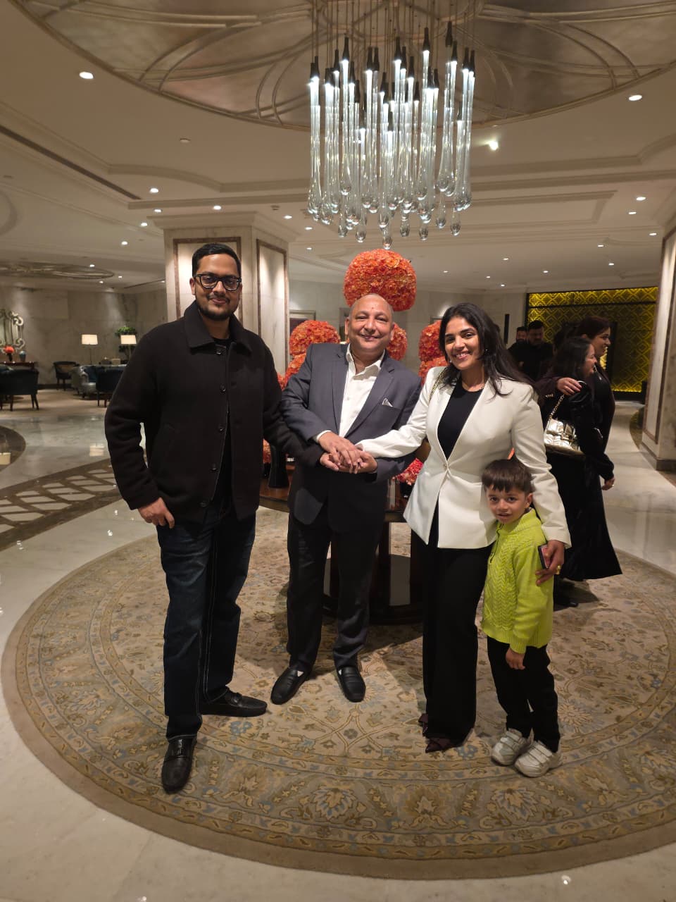 Mr. Manoj Garg with a couple in the hotel lobby