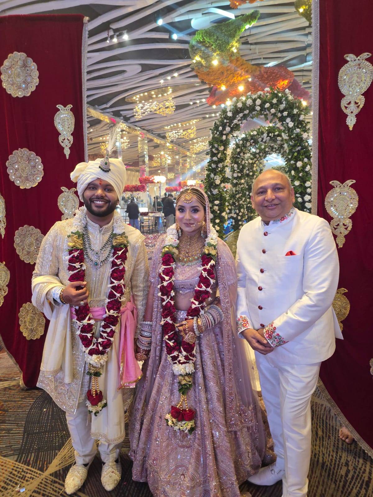 Bride and groom with Mr. Manoj Garg at the entrance